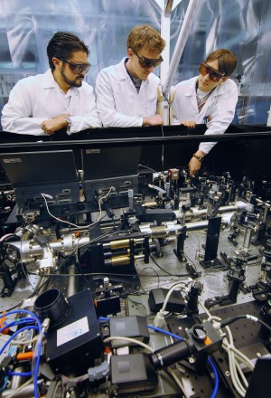 Daniel Headley (left), Marc Ramsey, and Jens Schwarz examine the performance of one of their optical clamps as it corrects for laser beam distortion in Sandia’s Z-beamlet laser.