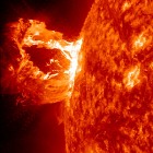 Extreme Ultraviolet Imaging Spectrometer Data on Solar Tsunami Used to Estimate Sun's Magnetic Field